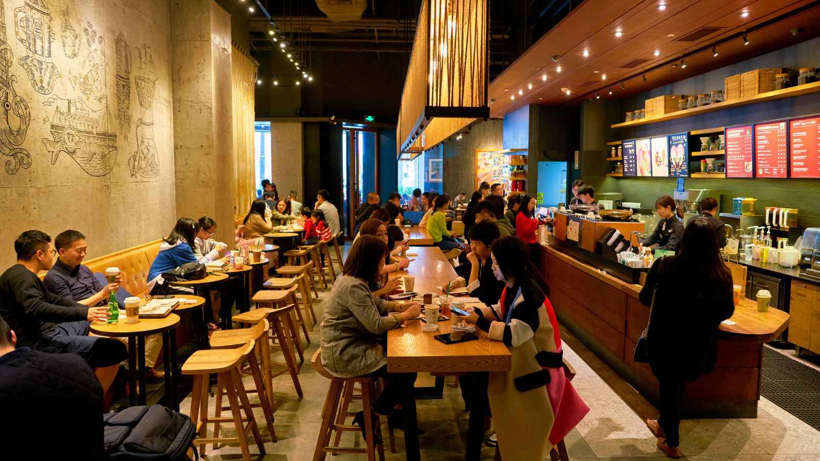 A photo of a restaurant packed with people.