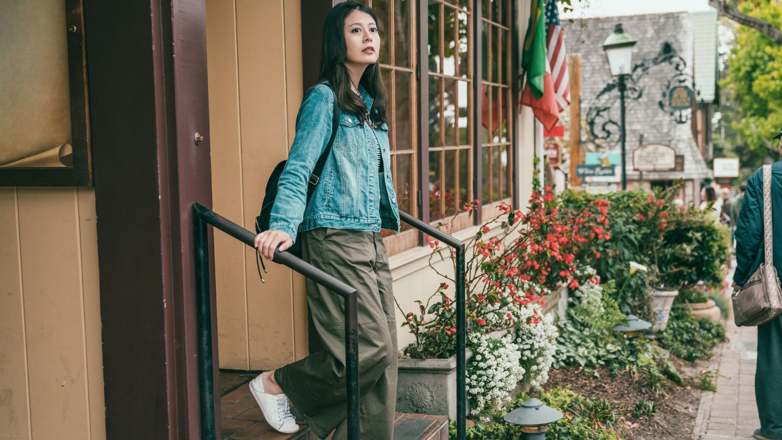 A photo of a Traveler walking slowly through a neighborhood.