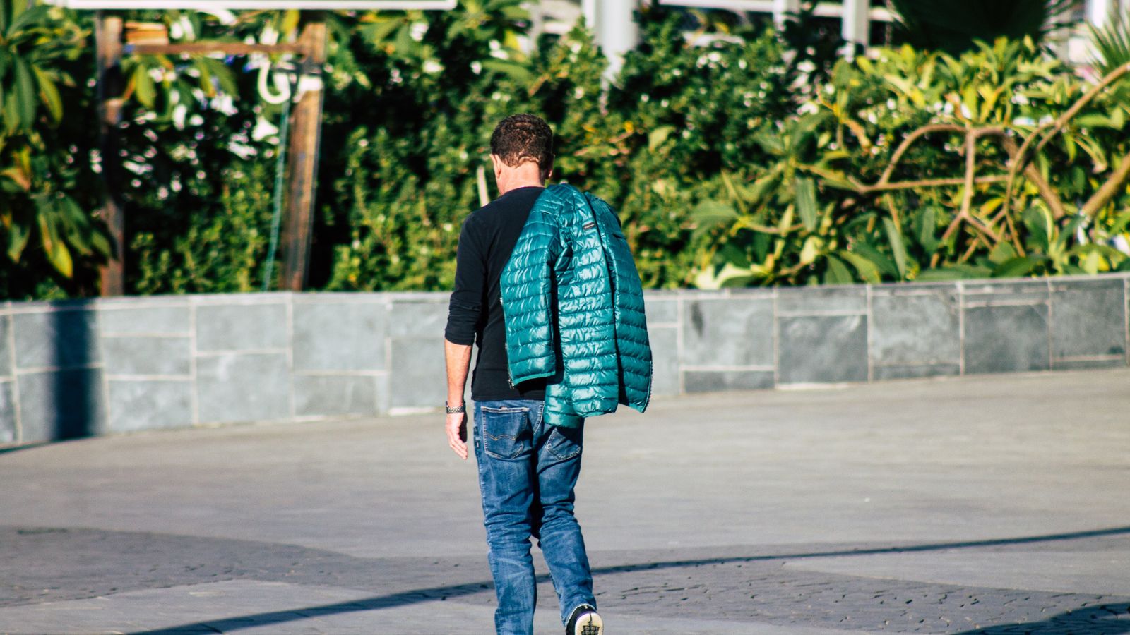 A photo of a man walking alone unfamiliar street.