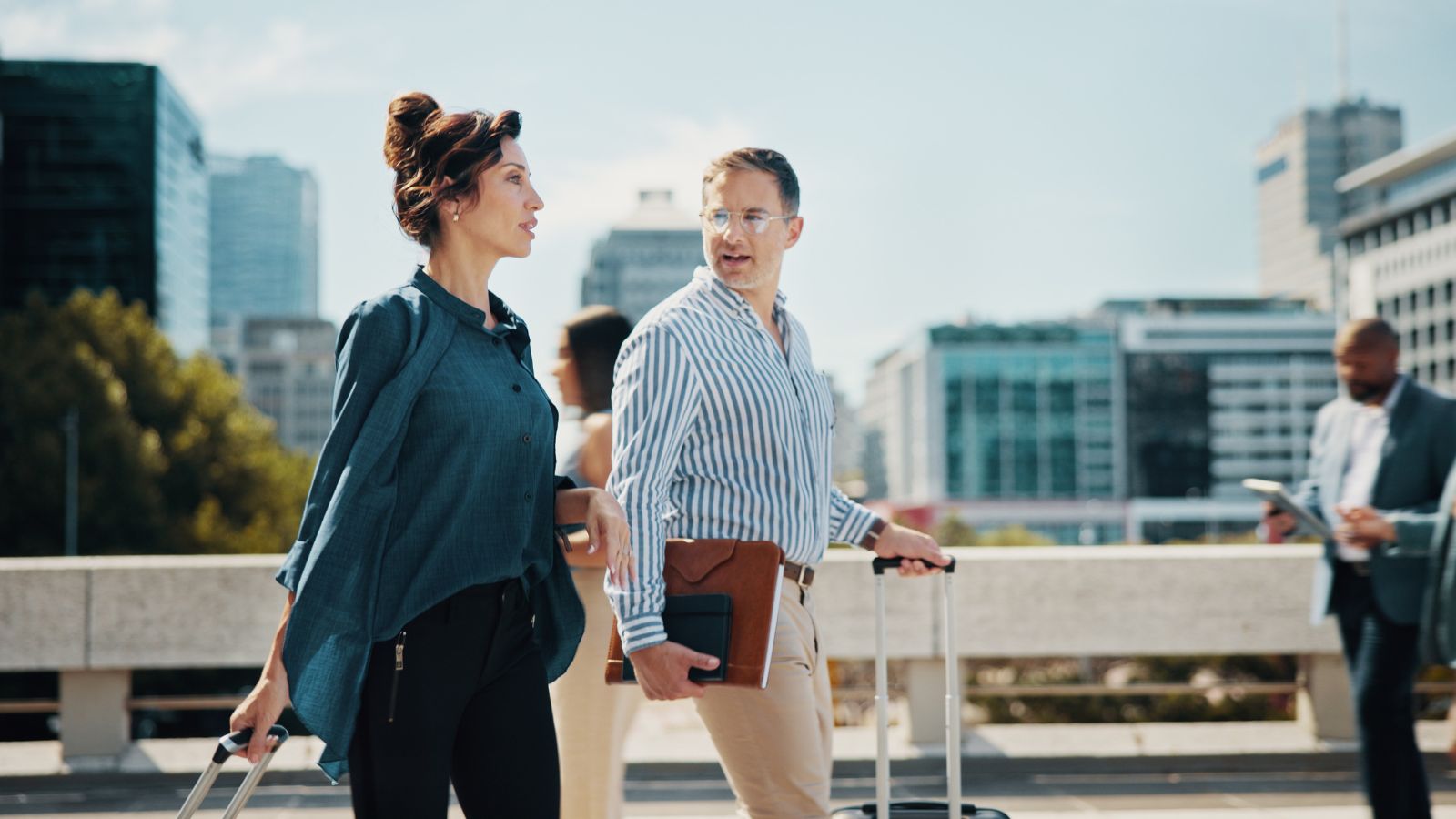 A photo of couple, looking busy talking while walking.
