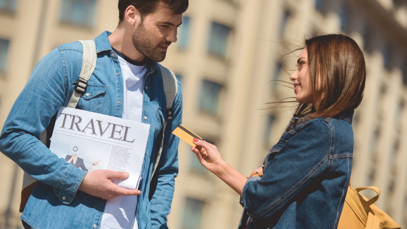 An image of a woman handing her credit card to a man.