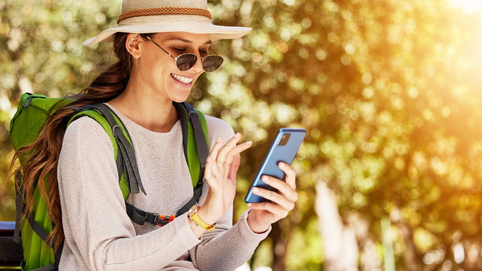 A woman smiling at her phone.