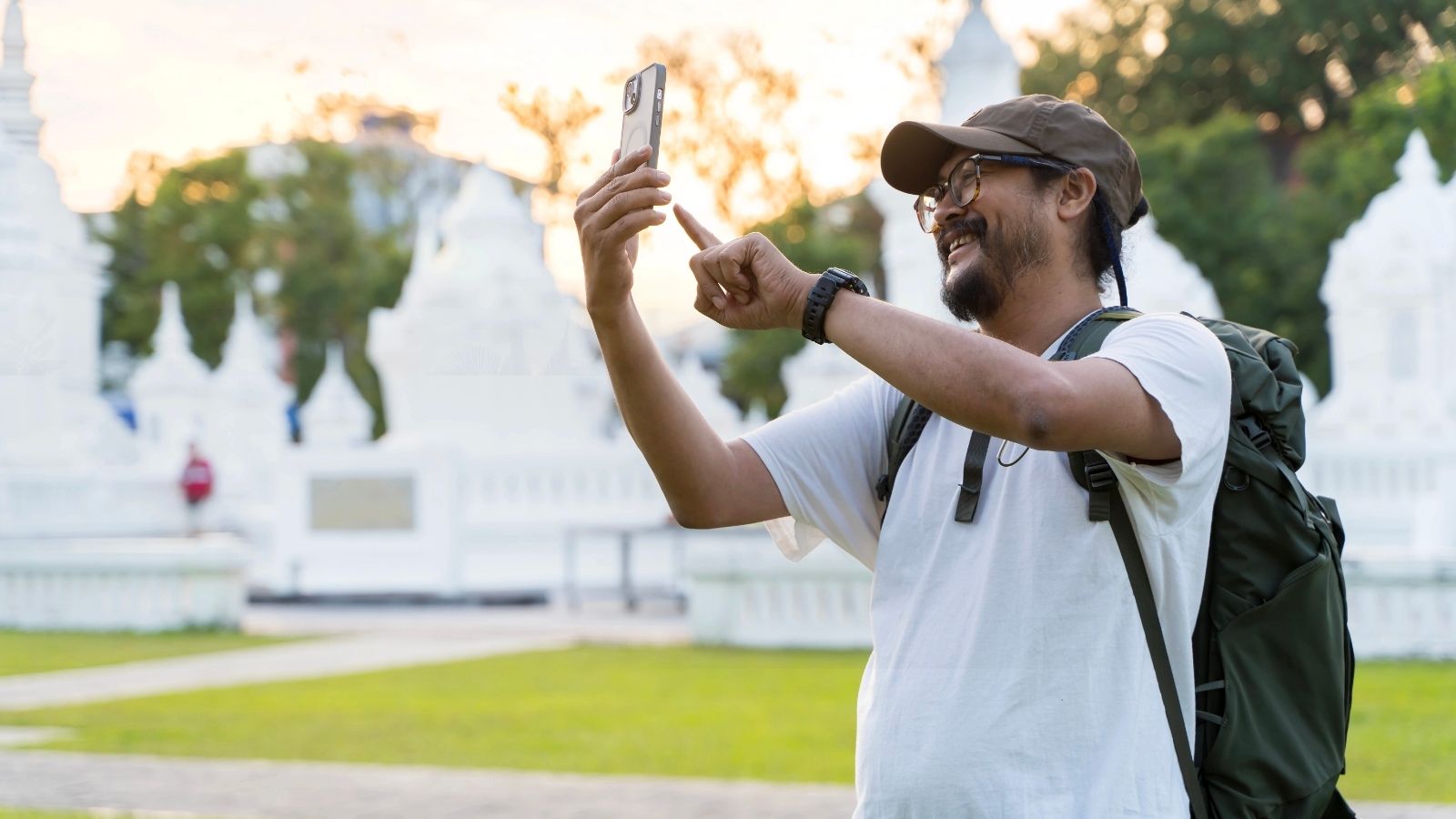 A tourist man taking pictures with this phone.