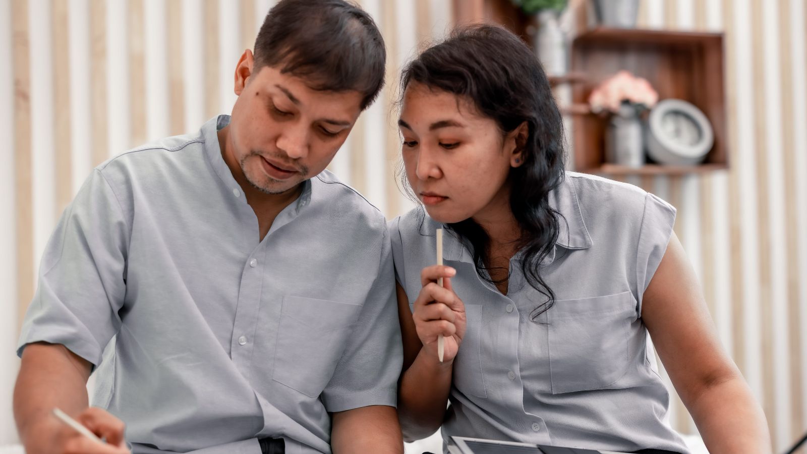A photo of romantic couple sitting together discussing travel plans calmly engaged conversation relaxed atmosphere.