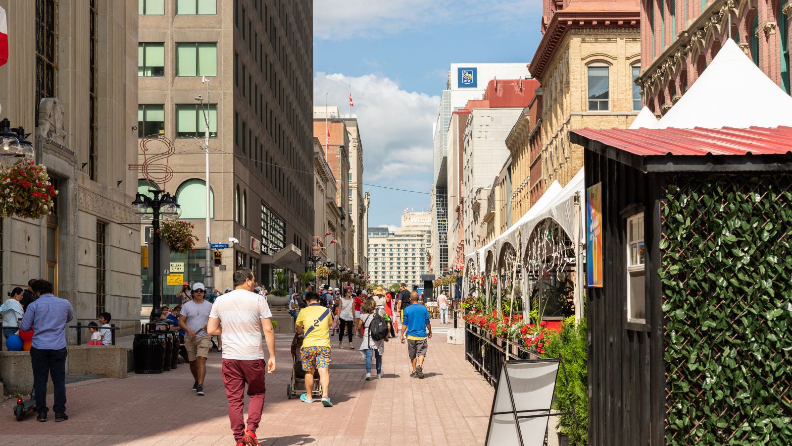A photo of clean walkable Canadian city street with wide sidewalks friendly atmosphere travelers exploring calmly.