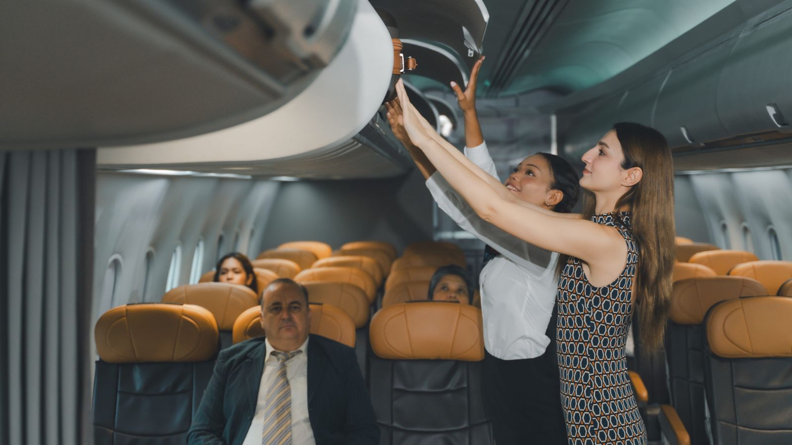 A photo of a crowded airplane boarding passengers standing in aisle placing luggage overhead bins busy cabin travel rush realistic.