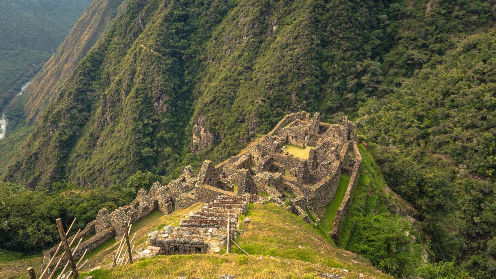 Stone terraces and ancient ruins along a mountain ridge on the Inca Trail in Peru.