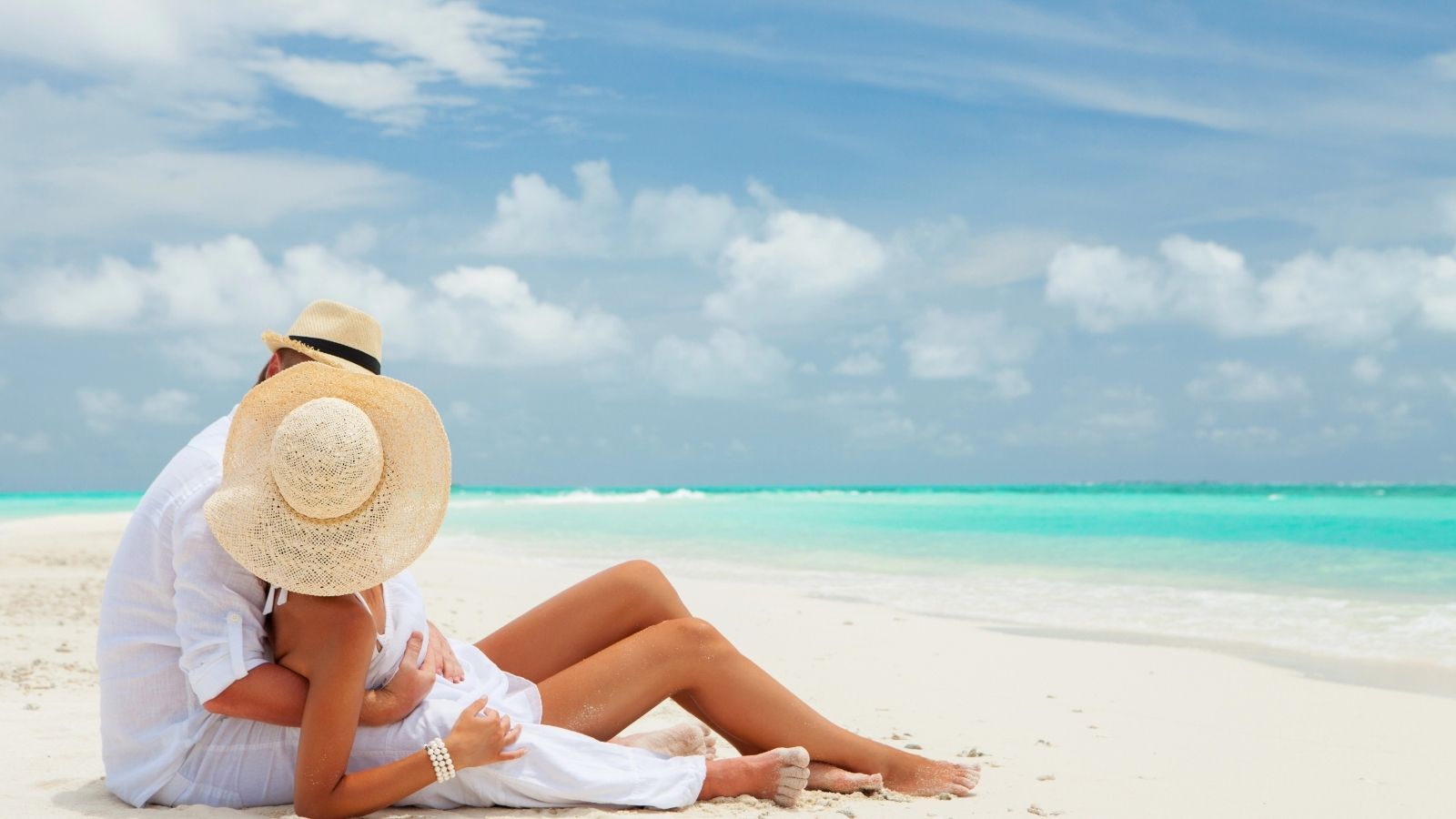 A couple sitting by the shore.