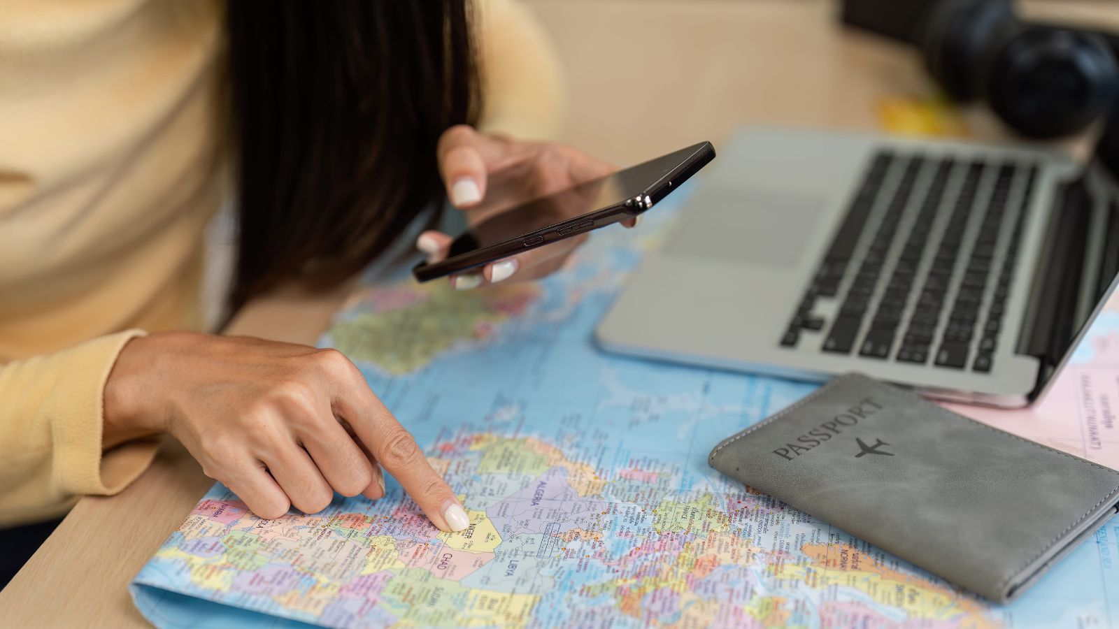 A photo of a traveler reading hotel reviews and checking location on a map on a laptop or smartphone.
