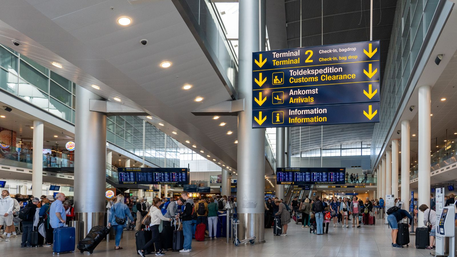 A photo of a peaceful early morning airport terminal with a few relaxed travelers boarding a flight, showing a smooth start to a trip.