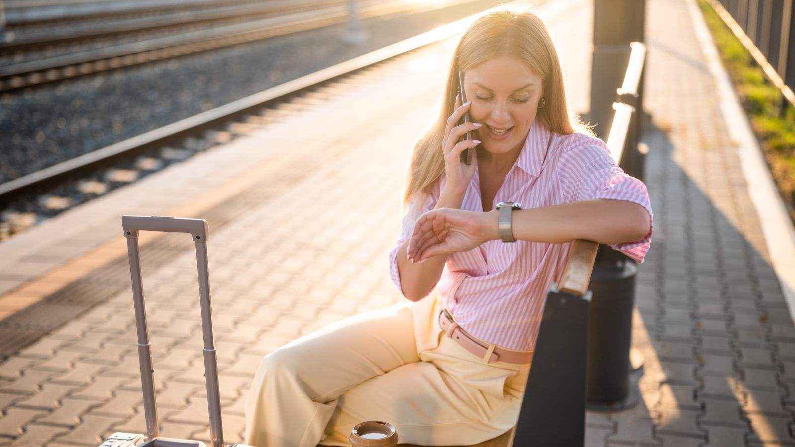 A photo of a woman in a city checking time or phone focused on schedule.