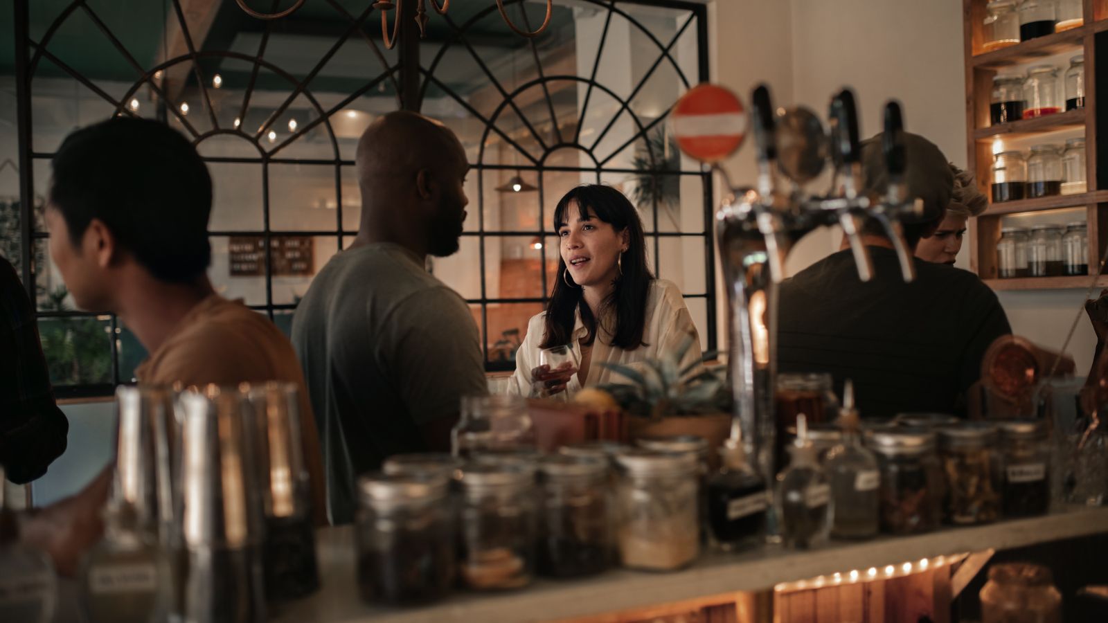 A photo of a people sitting quietly in a European café speaking softly, calm relaxed atmosphere