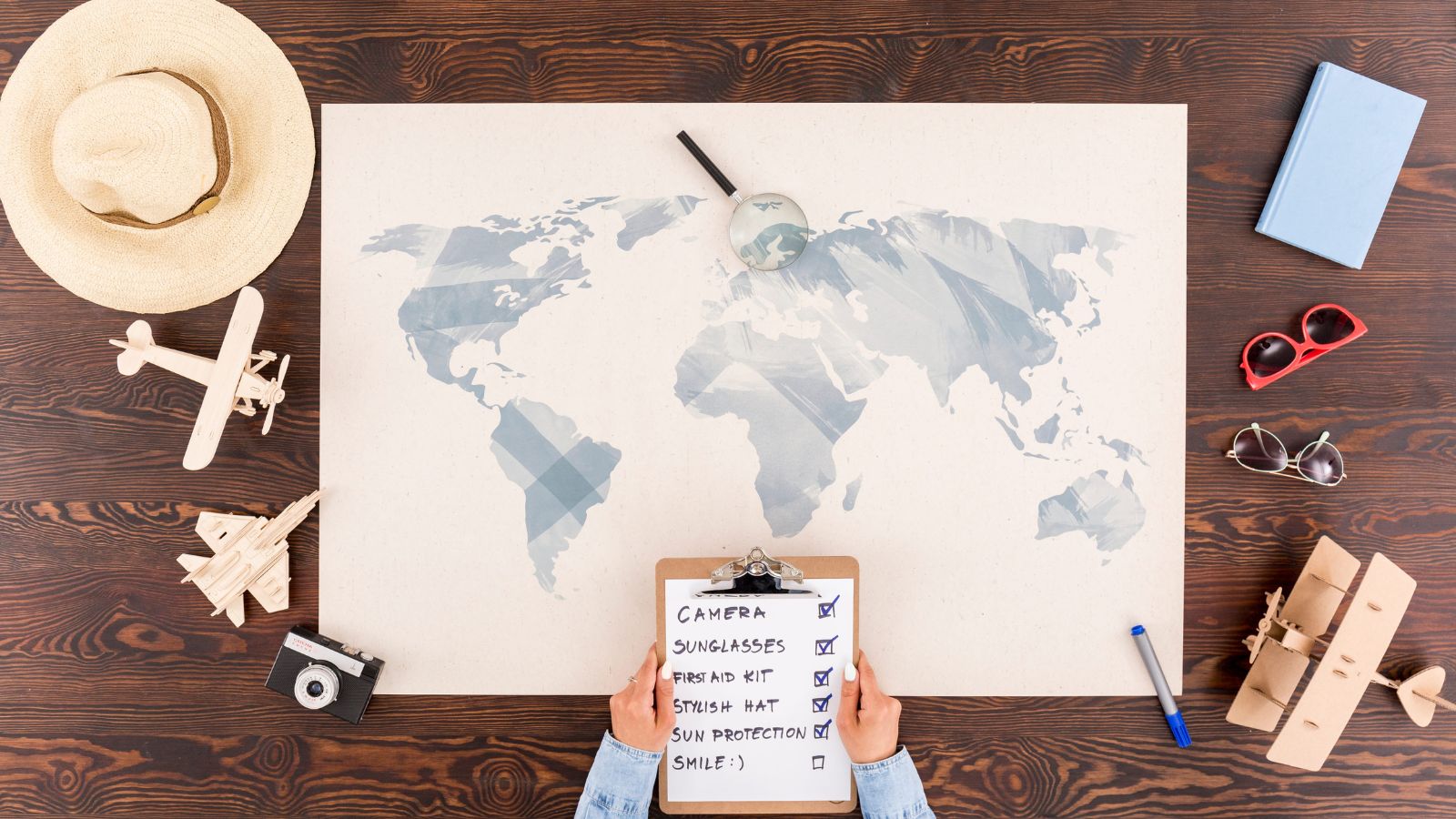 A photo of a traveler planning trip with notebook map and phone busy itinerary scheduling many activities travel planning flat lay natural light.