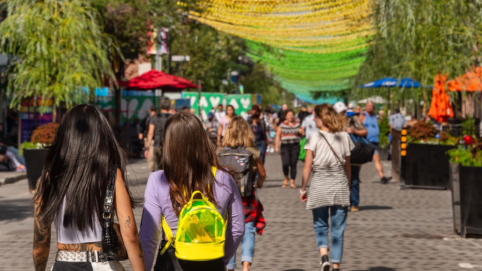 A photo of travelers and locals walking at a street in Canada.