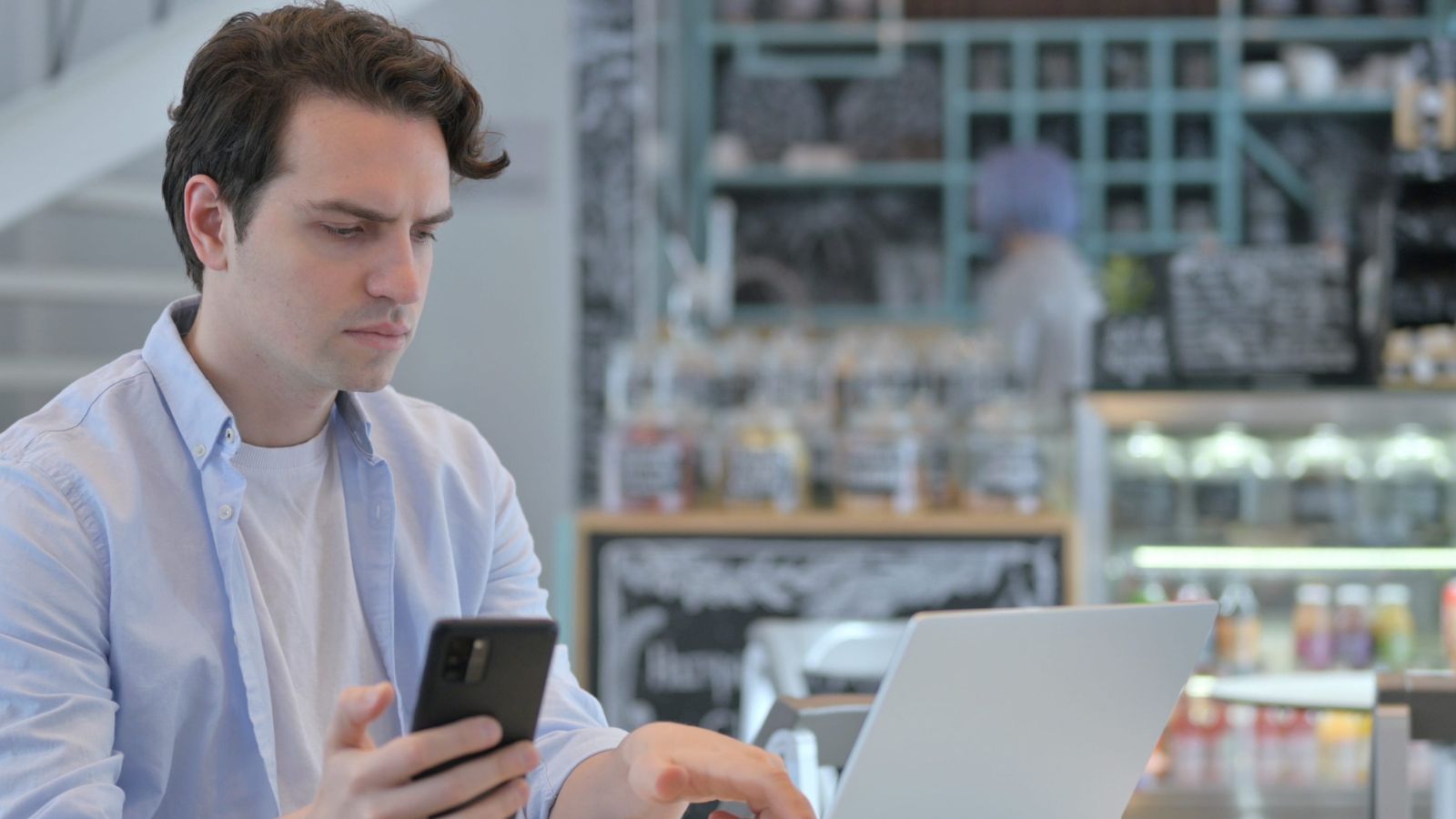 A photo of a traveler looking puzzled at laptop or phone checking hotel ratings thoughtful concerned realistic travel moment indoor natural light candid.