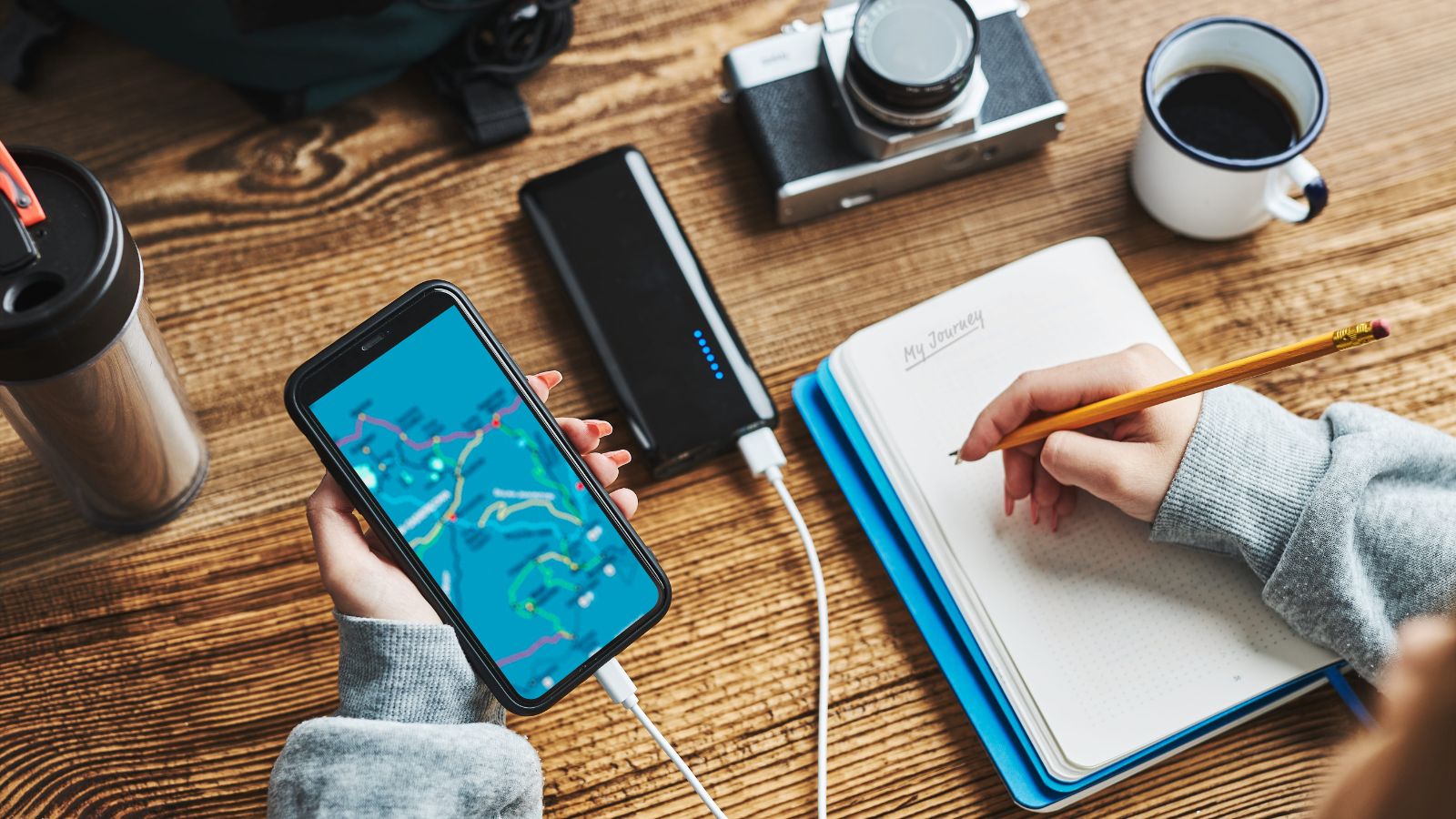 A photo that shows a traveler planning a trip with a long checklist of landmarks, maps, and notes spread across a table.