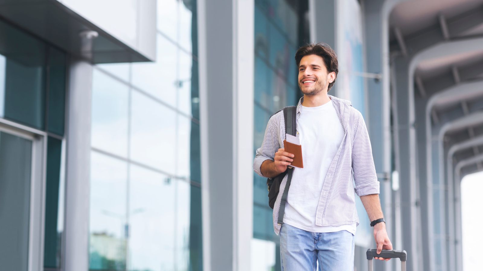 A photo of a traveler walking confidently through travel setting relaxed composed seamless journey experience calm atmosphere natural light candid.