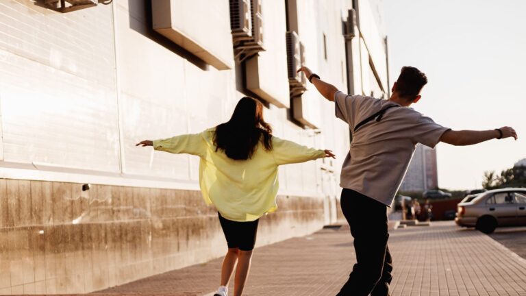 A photo of a romantic couple walking quickly through tourist area slightly distracted busy schedule fast paced travel moment.