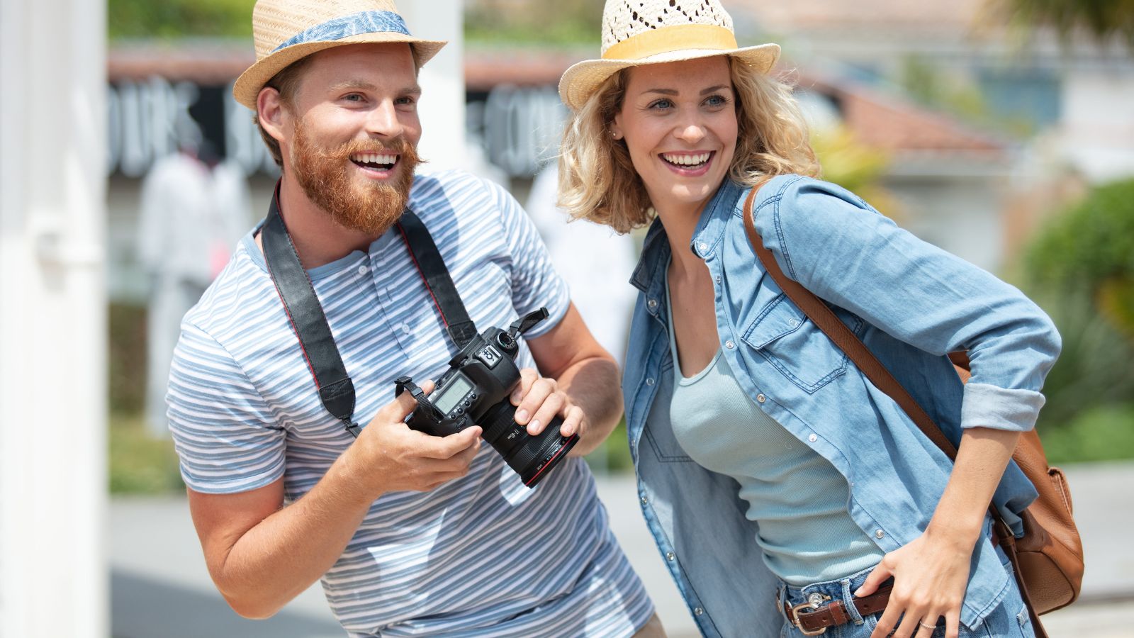 Photo of a couple starting a trip together in a beautiful travel destination, looking excited and curious.