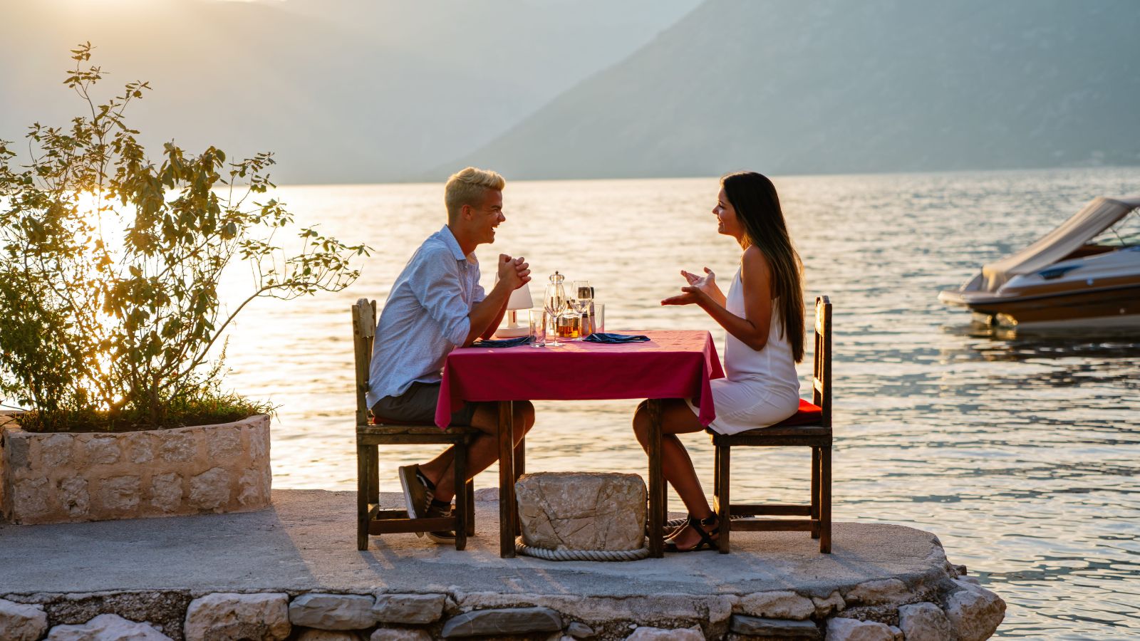 A photo of a couple relaxing together overlooking scenic view sunset romantic peaceful moment intimate travel experience natural light.