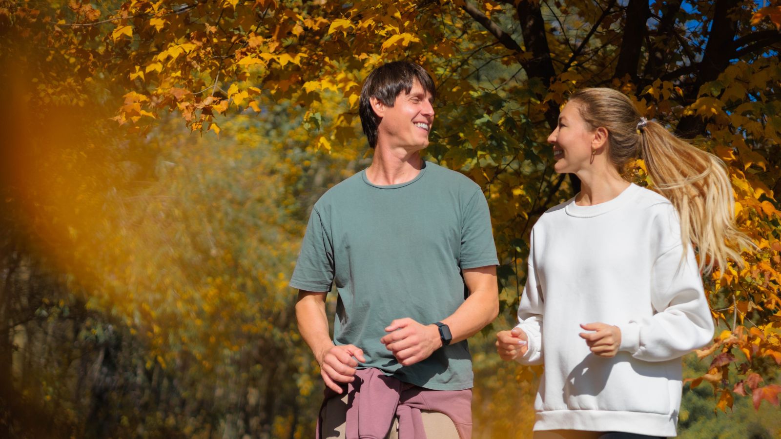 A photo of couple walking side by side relaxed enjoying shared moment aligned pace travel experience natural.