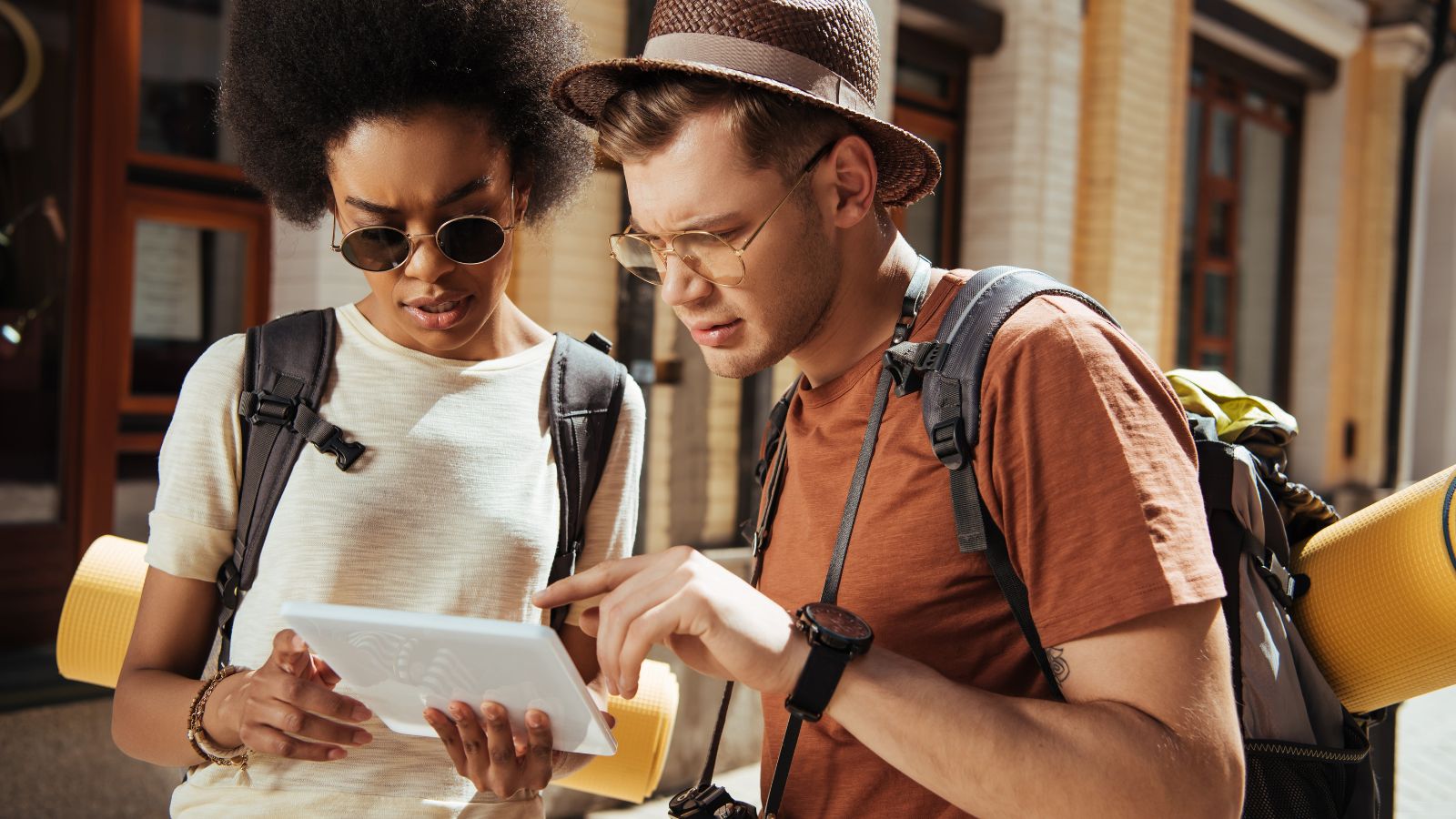 A photo of a couple travelers seriously looking at the map.