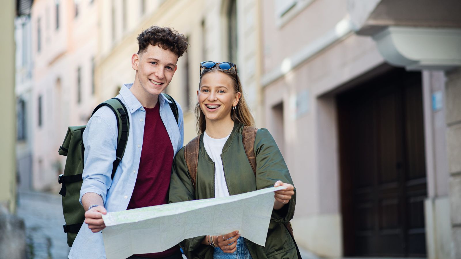 A photo of a couple walking through a charming historic European street, exploring and enjoying the surroundings together.