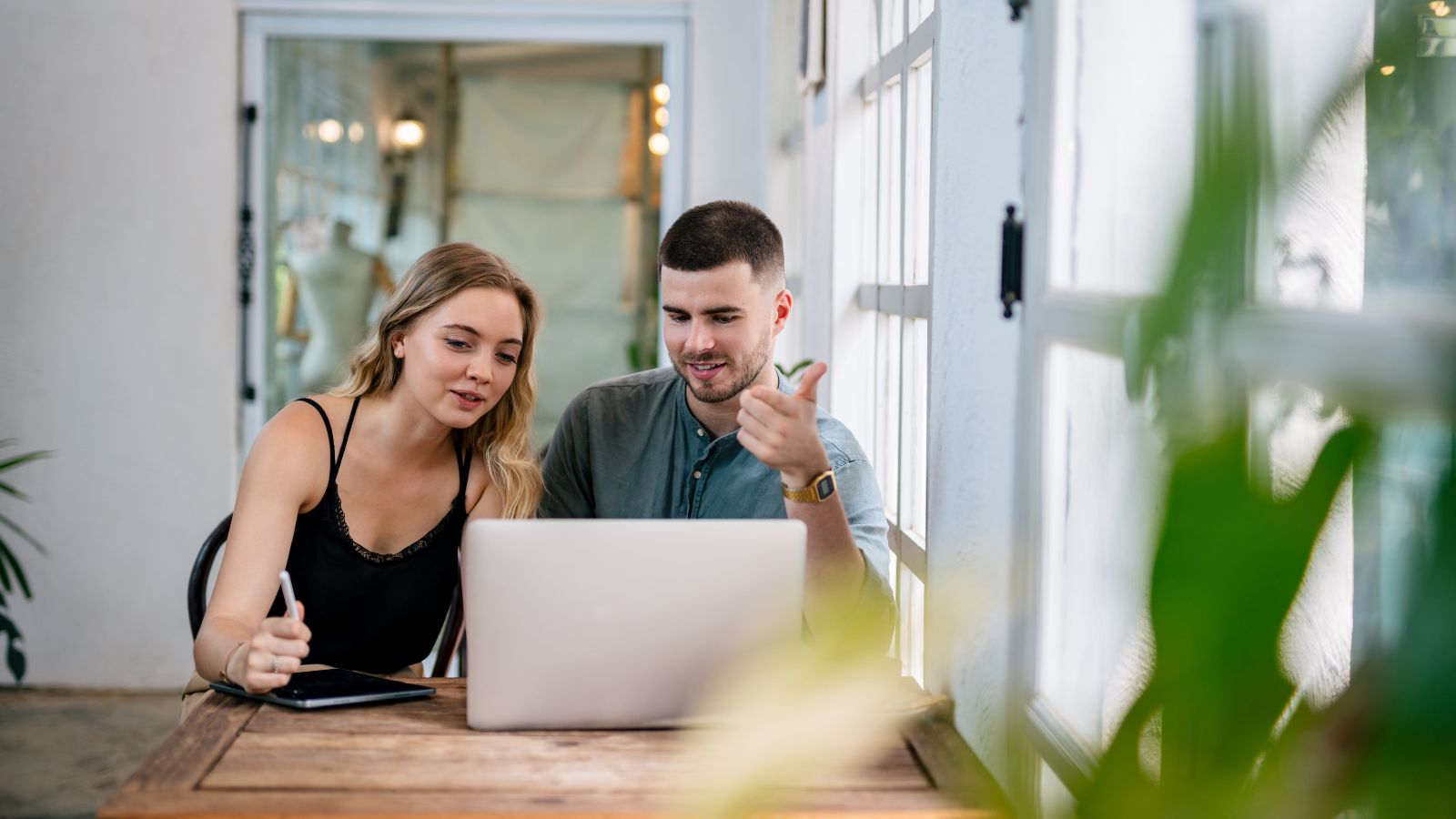 A photo of romantic couple planning getaway looking at laptop or map calm cozy setting choosing peaceful destination relaxed mood natural light candid.