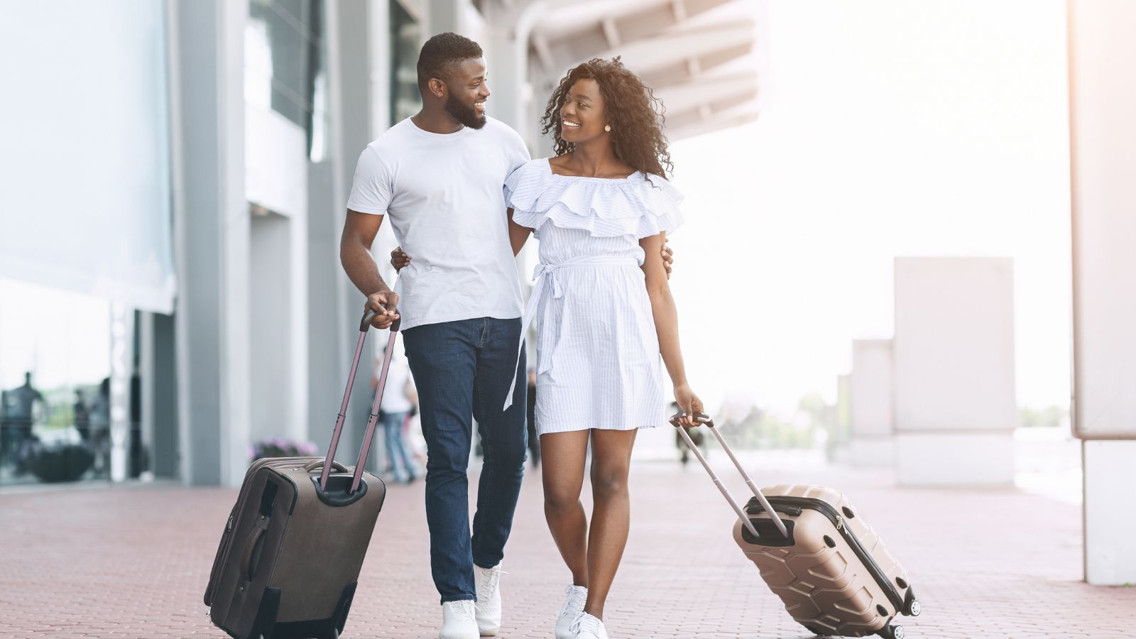 A photo of two lovely couple walking with luggage