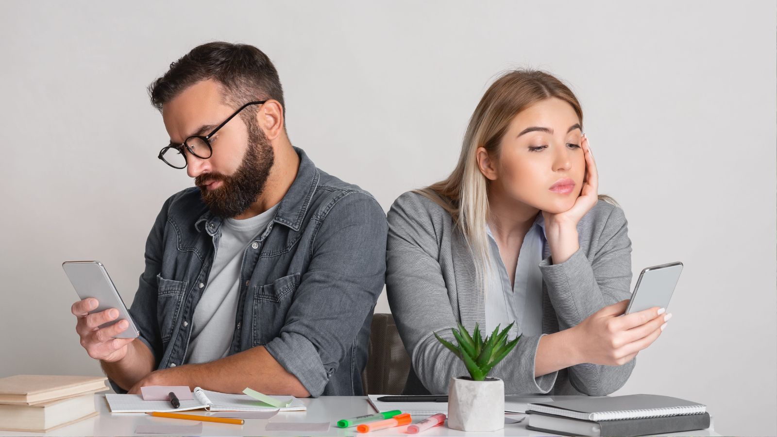 A photo of couple sitting together looking at phone or travel plan with different expressions subtle tension mismatched expectations.