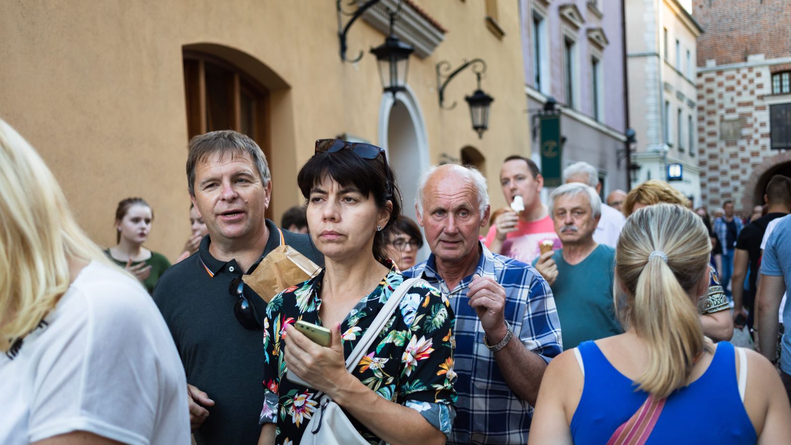 A photo of a traveler arriving in crowded busy city looking slightly overwhelmed busy streets people noise urban travel.