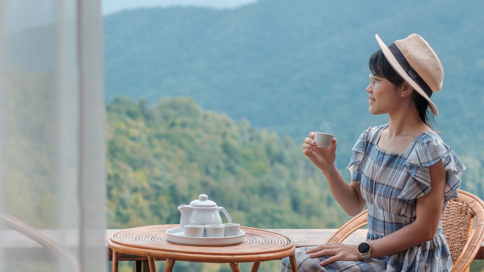 A photo of a traveler sitting at cafe or scenic spot relaxed slow travel enjoying moment no rush natural candid.