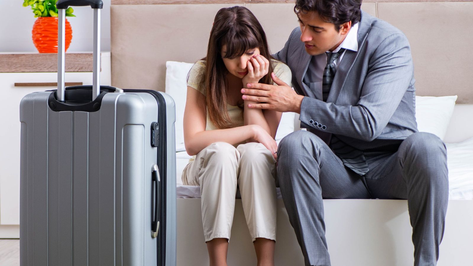 A photo of a couple walking long distance with luggage or looking tired in hotel room small or inconvenient travel frustration candid realistic.
