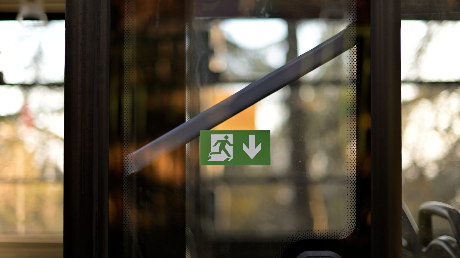 A photo of a building door showing an exit sign