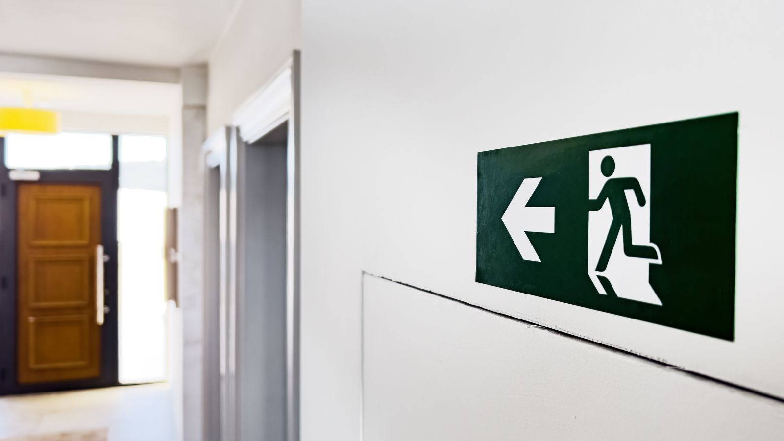 A photo showing hotel room door with visible evacuation map and emergency exit diagram.