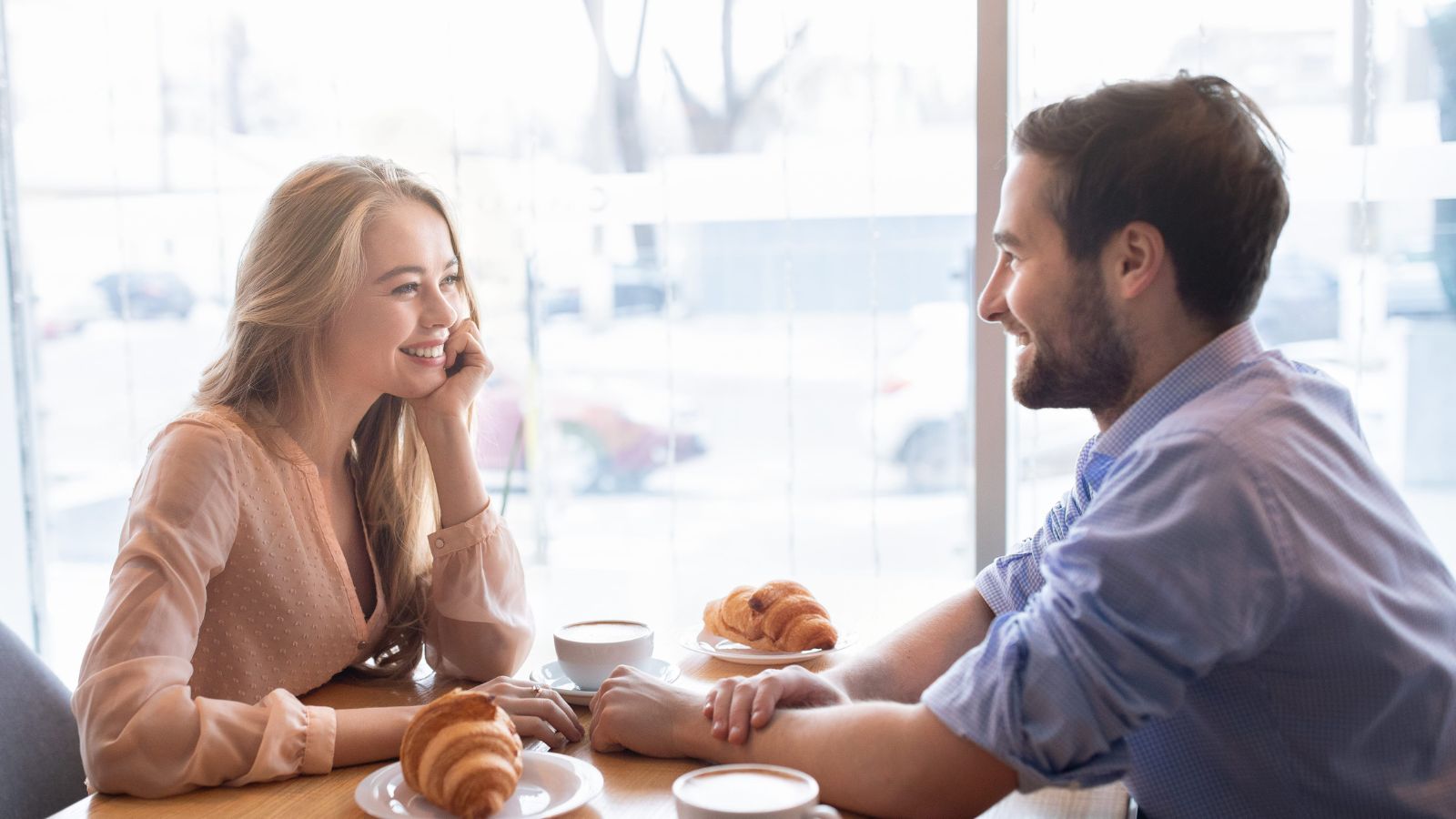 A photo of couple enjoying slow morning breakfast or relaxing at cafe peaceful travel pace no rush romantic lifestyle natural light candid.