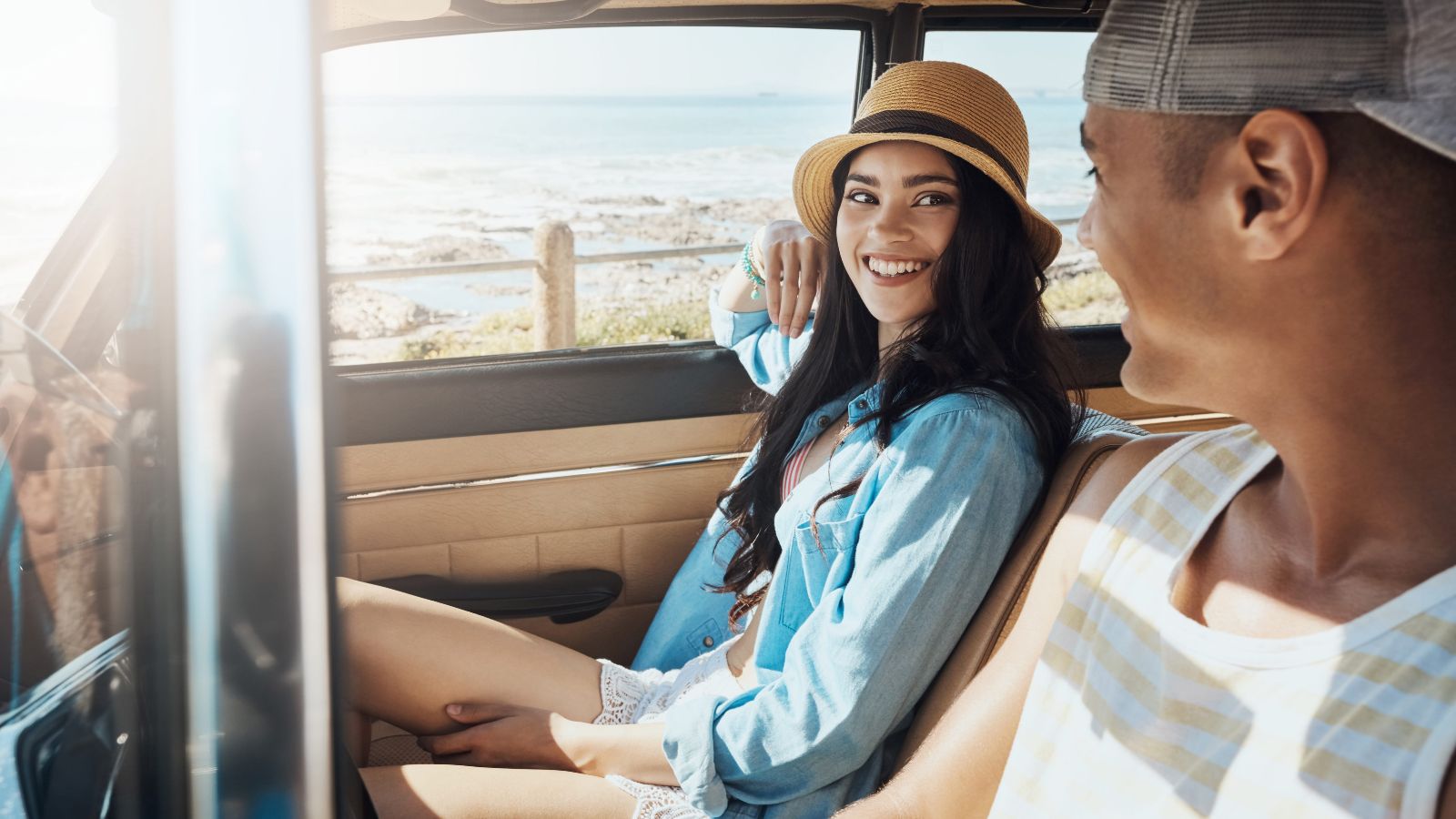 A photo of happy travelers continuing a road trip through a beautiful landscape after a refreshing stop.