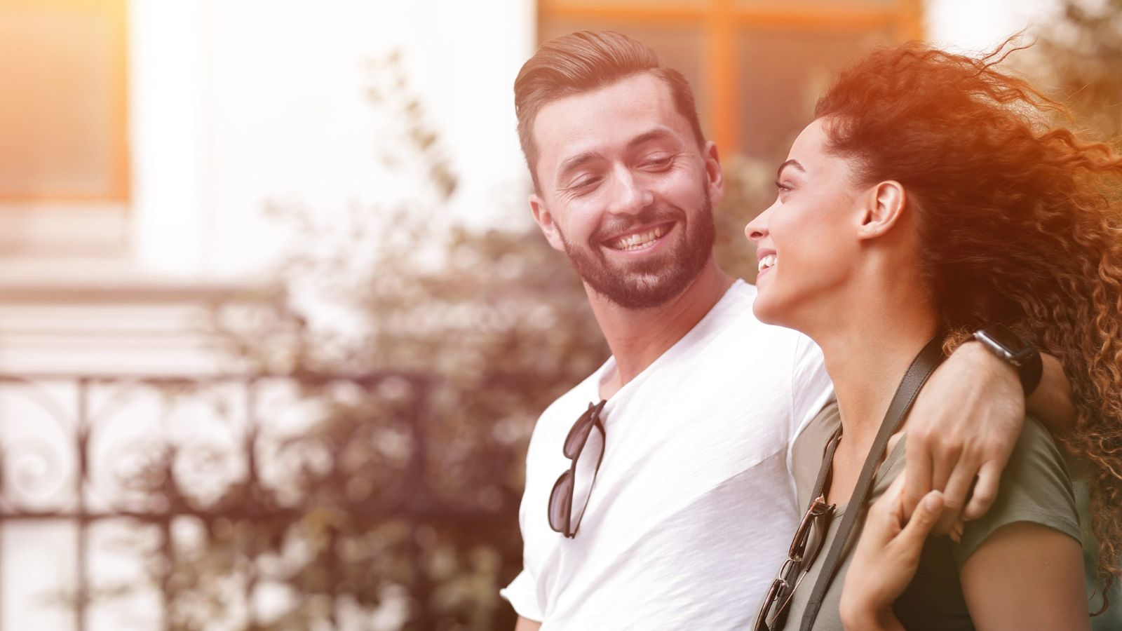 A photo of a couple happily exploring a charming city street together at a relaxed pace, smiling and enjoying the moment.