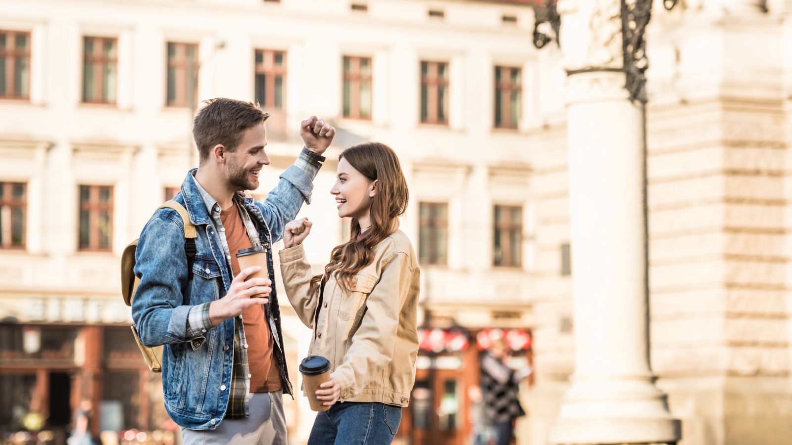 A photo of a happy travelers exploring a beautiful historic European square with cafés and old architecture.