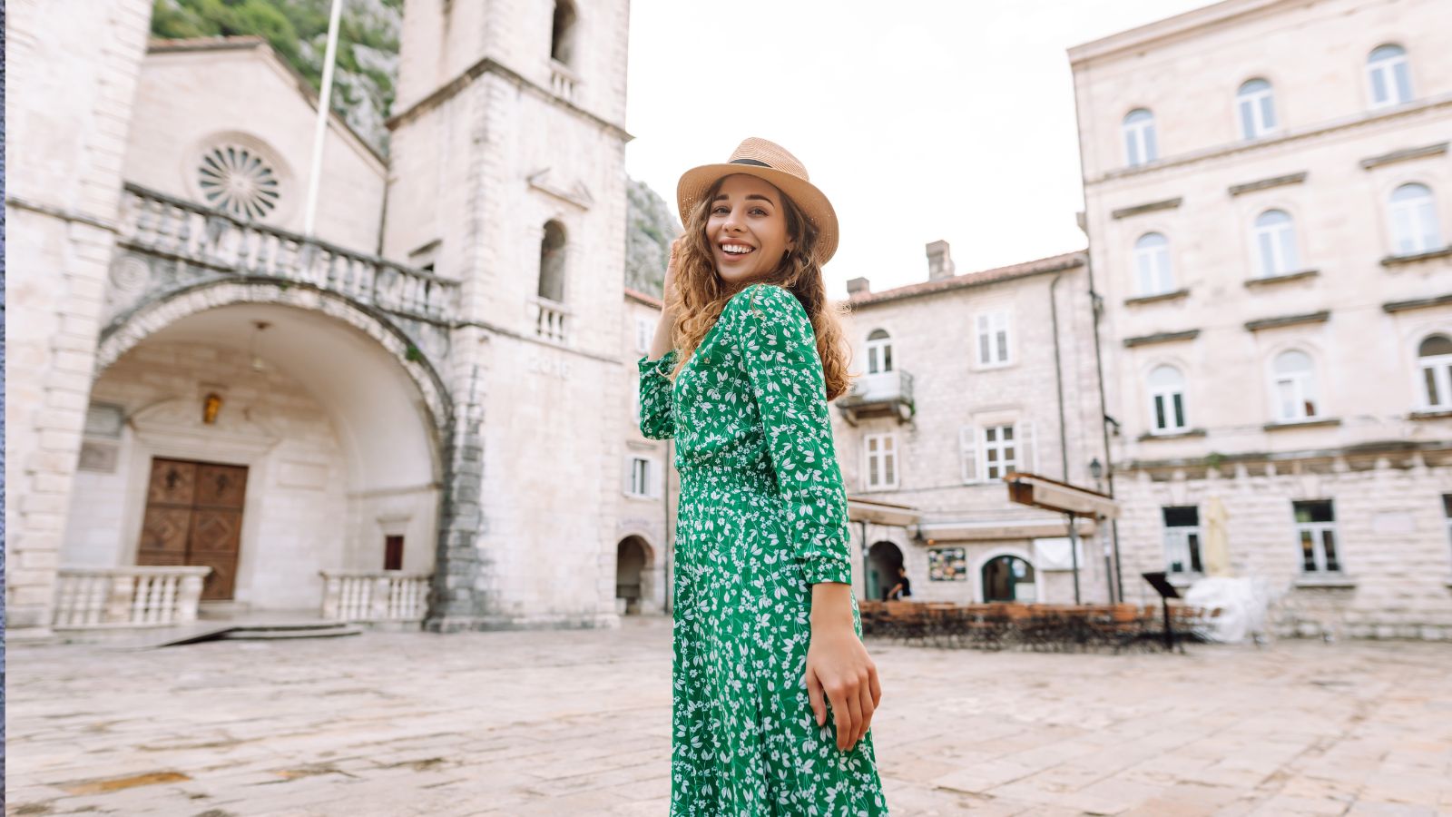 A photo of a standing posing happily at the center of a square