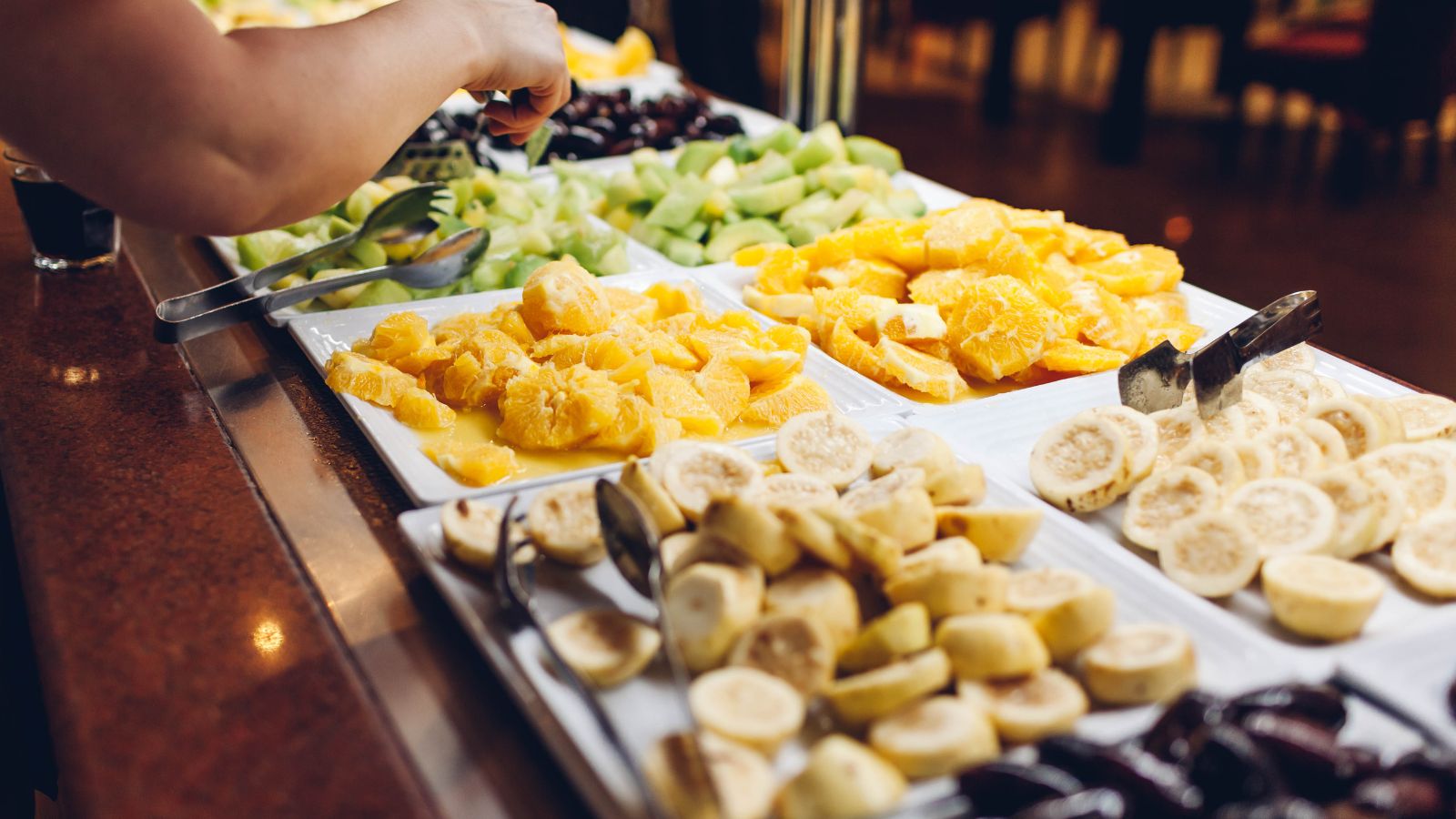 Photo of hotel breakfast buffet with pastries, fruit, coffee.