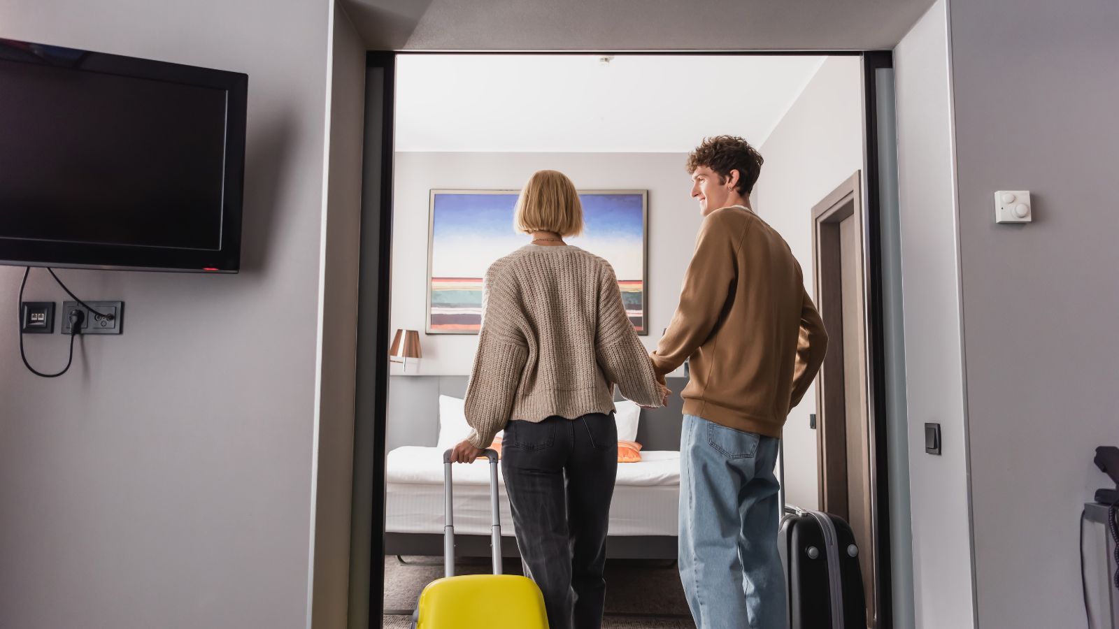 A photo of guests pulling suitcases