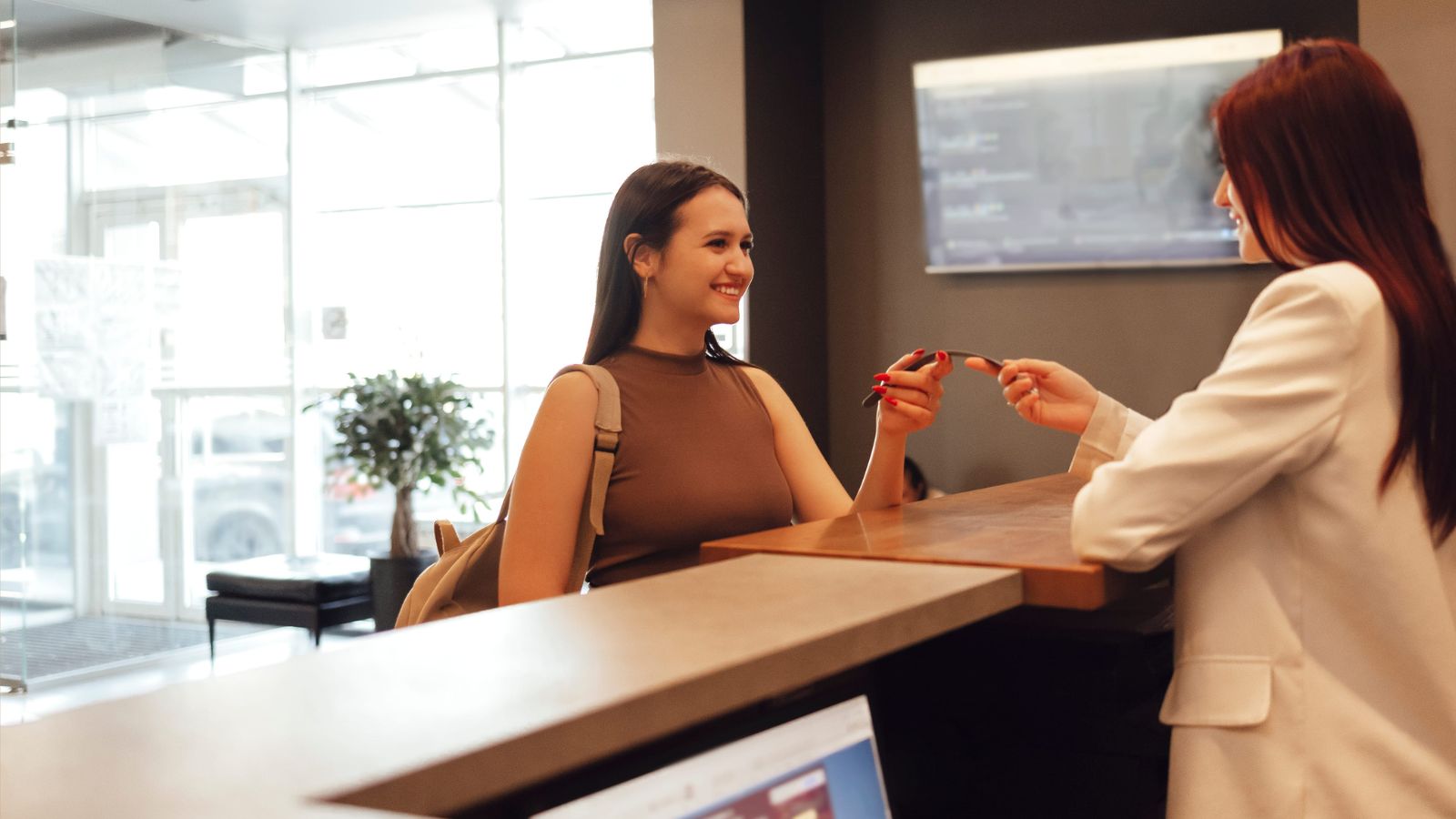 A photo of a woman receiving bed key.