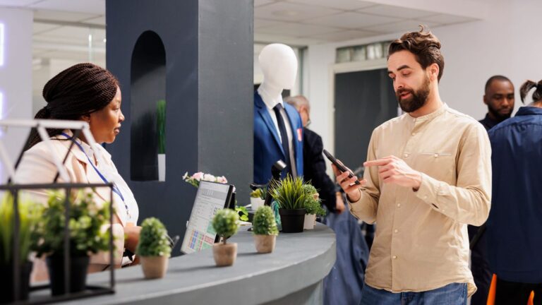 A photo of a man facing hotel reception.