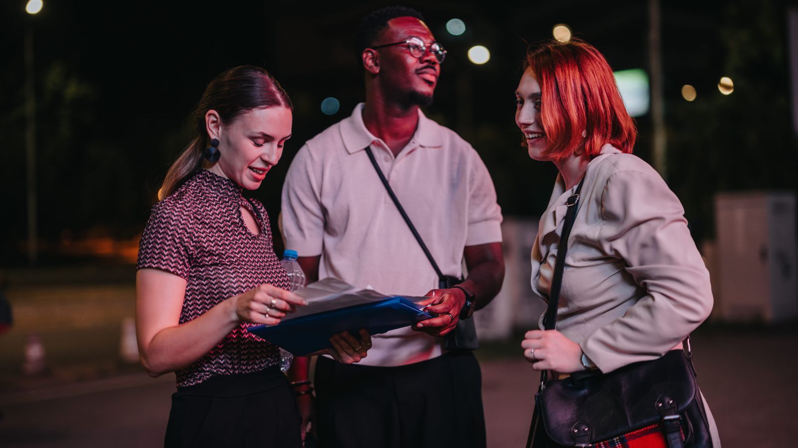A photo of a travelers looking tired while walking through a busy European city at night searching for a restaurant.