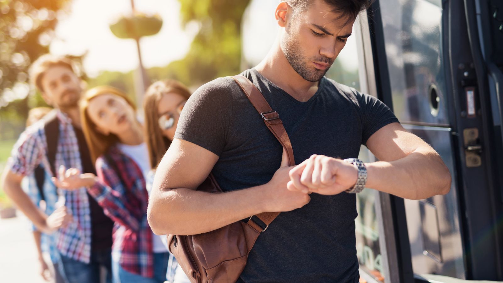 A photo of a traveler walking quickly through crowded tourist area checking schedule on phone looking stressed rushed travel moment.