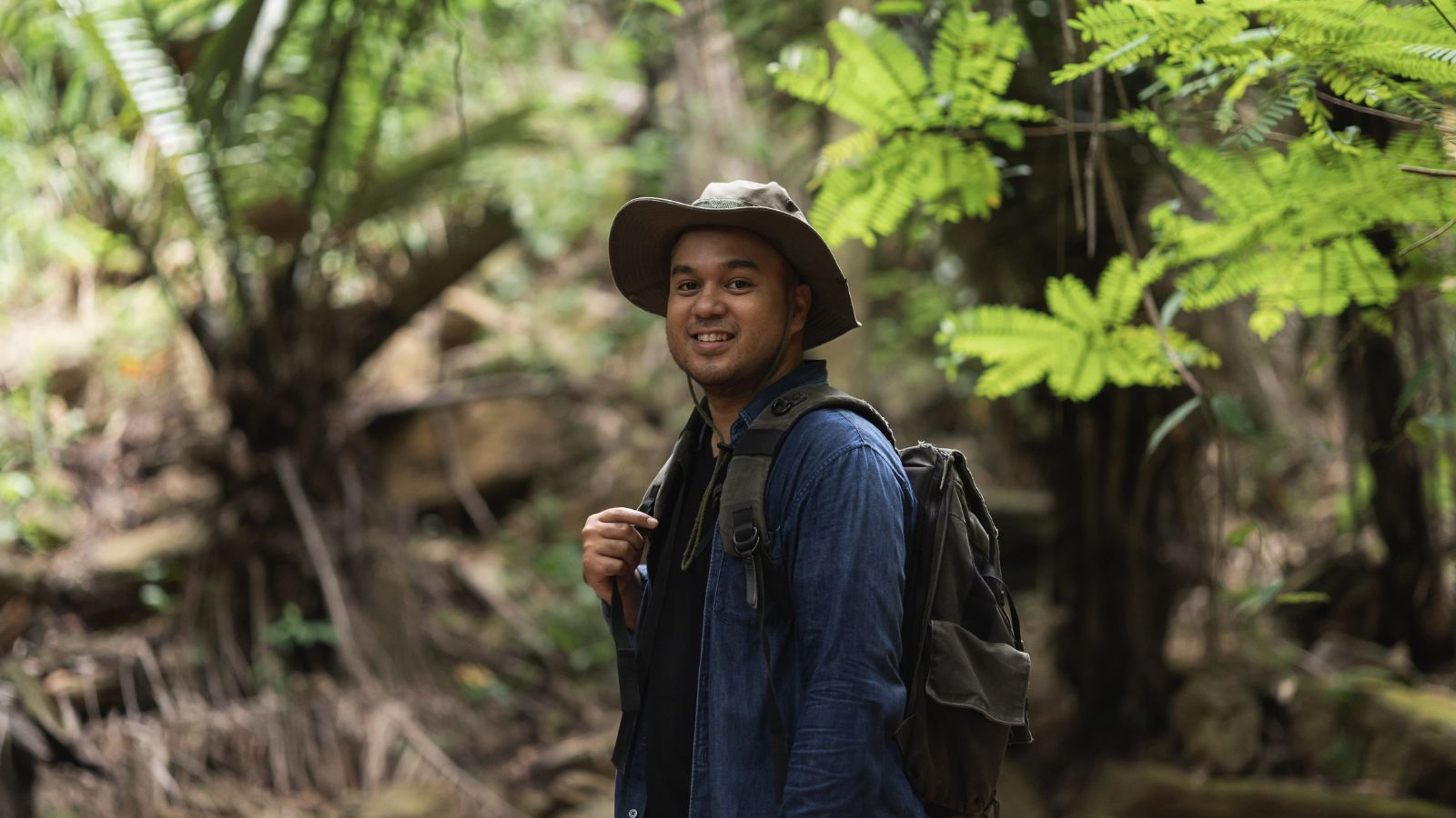 A photo of a man posing comfortably in one destination enjoying surroundings relaxed unhurried travel experience peaceful atmosphere.