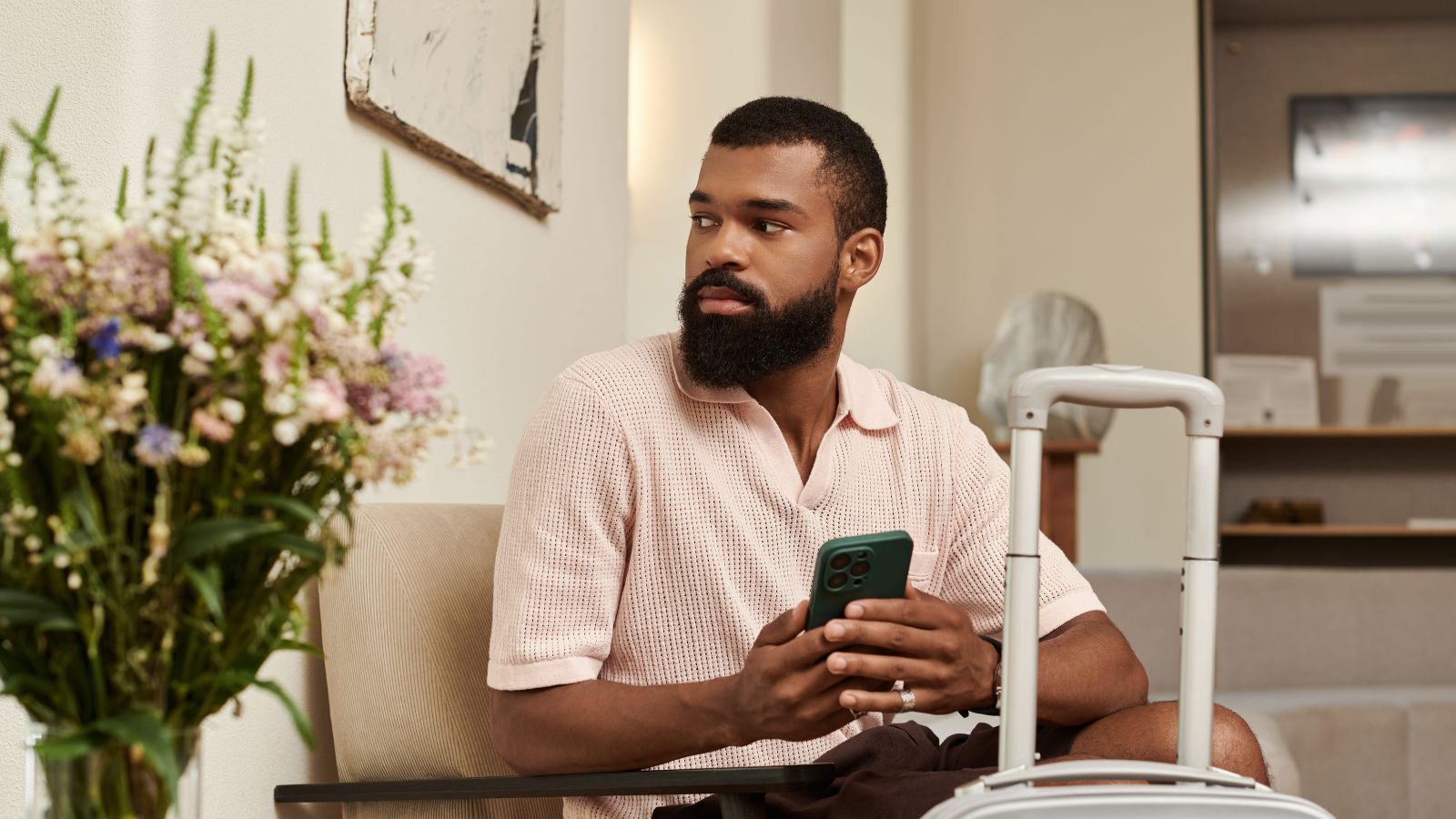 A photo of traveler arriving at budget hotel entrance looking slightly disappointed or unsure assessing surroundings.