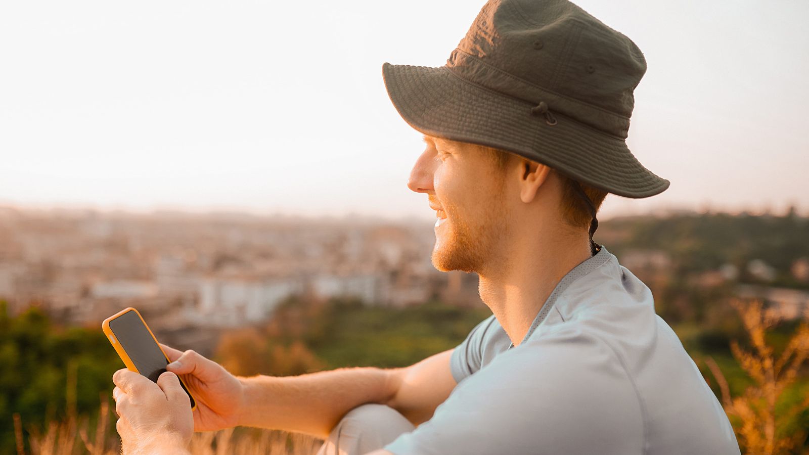 A photo of a traveler in scenic destination looking at phone instead of surroundings distracted missing moment travel experience.