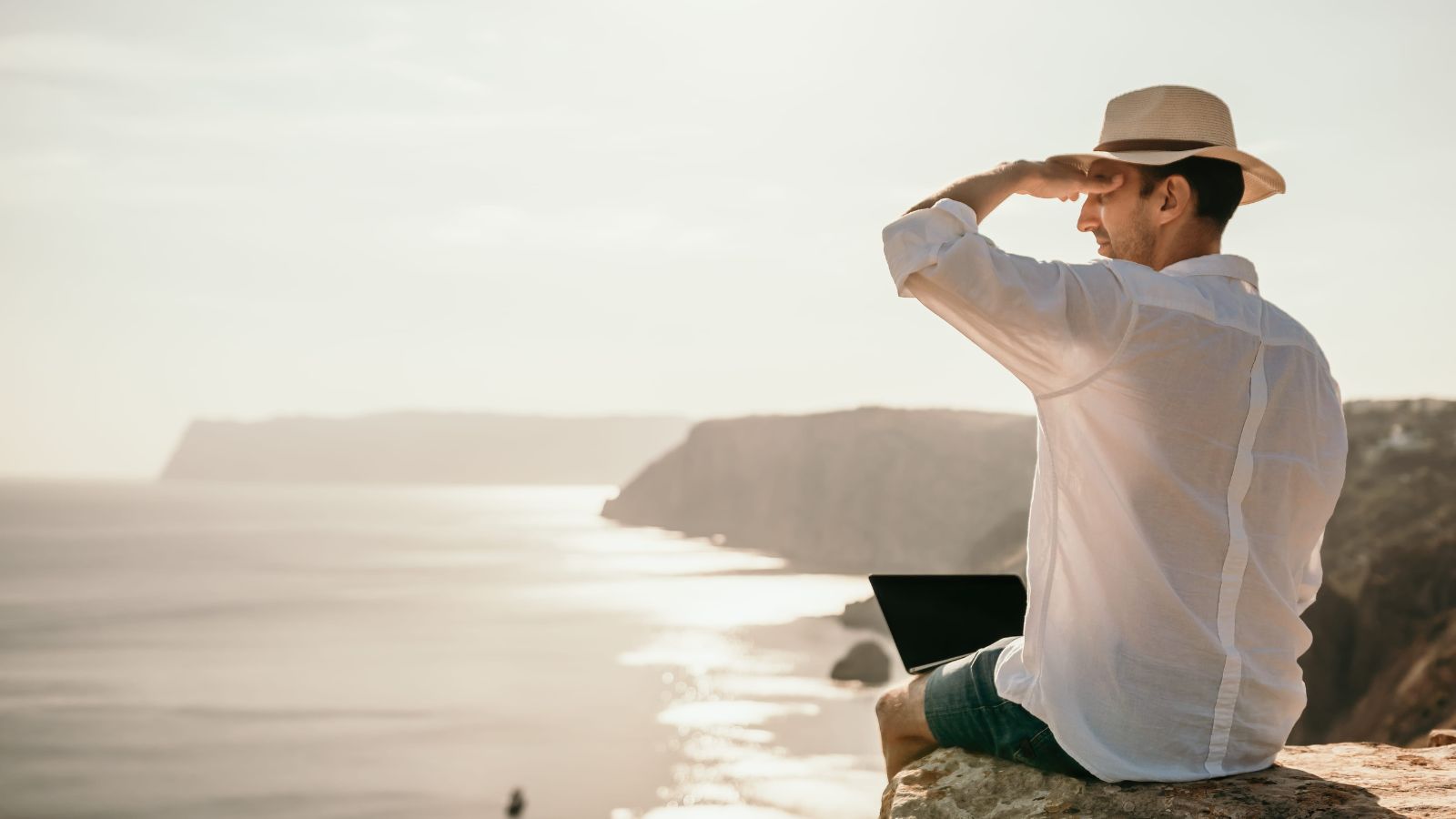 A photo of a traveler sitting peacefully enjoying scenic view relaxed unhurried travel moment calm atmosphere.